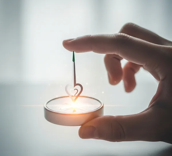 Person looking at a compass, symbolizing inner guidance